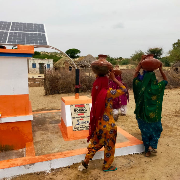 non-profit-06 Women carrying vessels to get water from village well