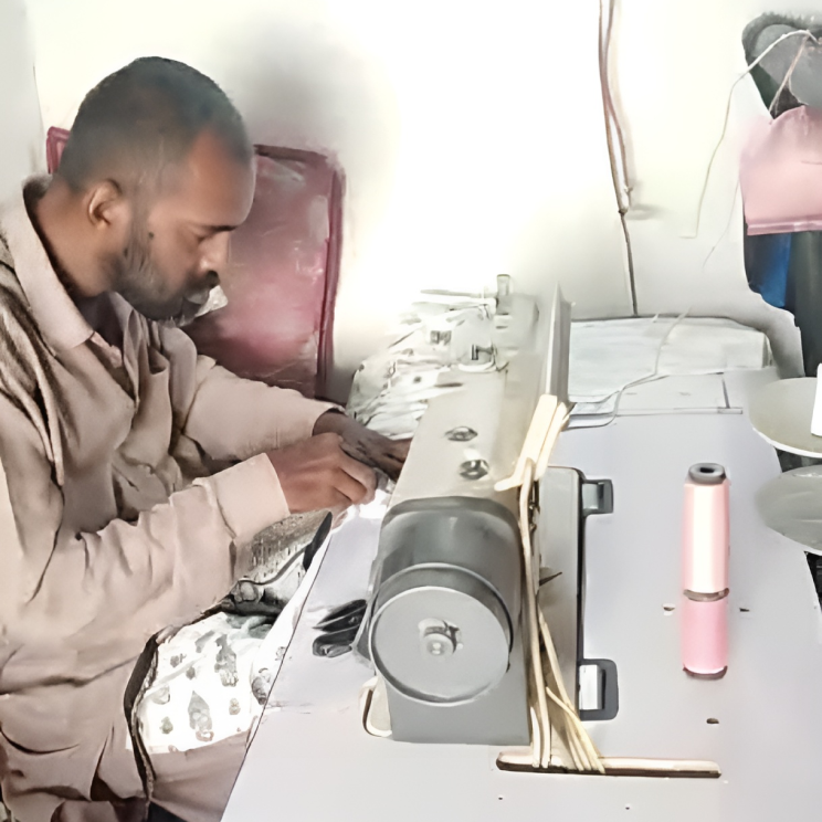non-profit-06 Man using sewing machine to create clothing and earn wages